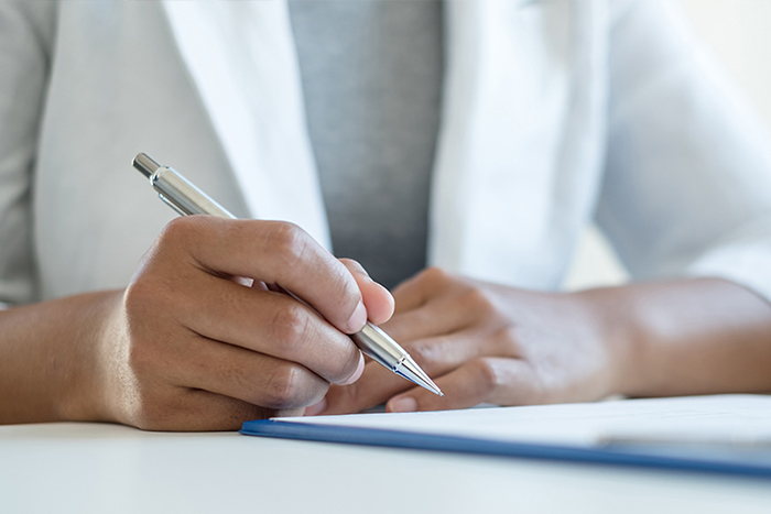 Two people sitting at a conference table in an office conducting an interview.