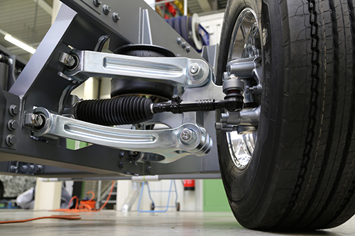Close-up of truck wheel and suspension system with steering components
