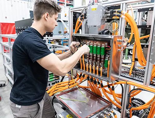 Person working on testing equipment in test lab