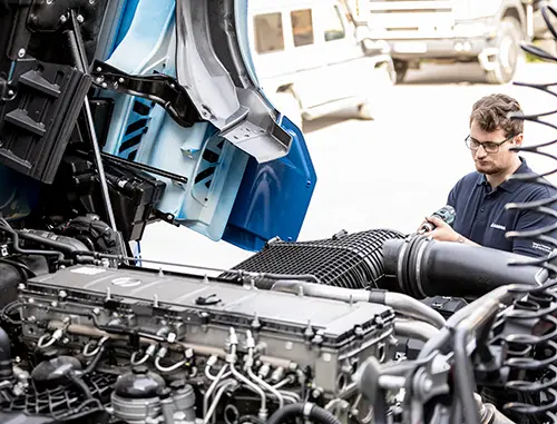 A person working on a truck transmission
