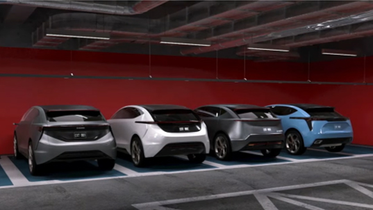 Four vehicles parked in a horizontal row in a parking garage