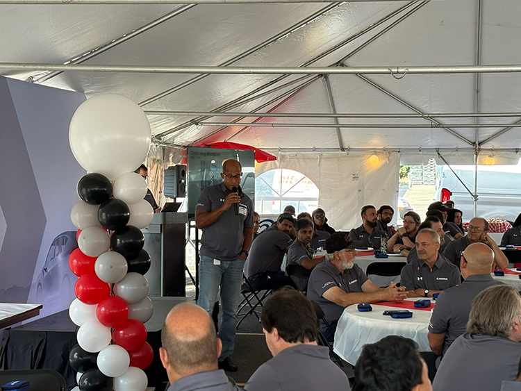 President Diba Ilunga talks to employees during luncheon.