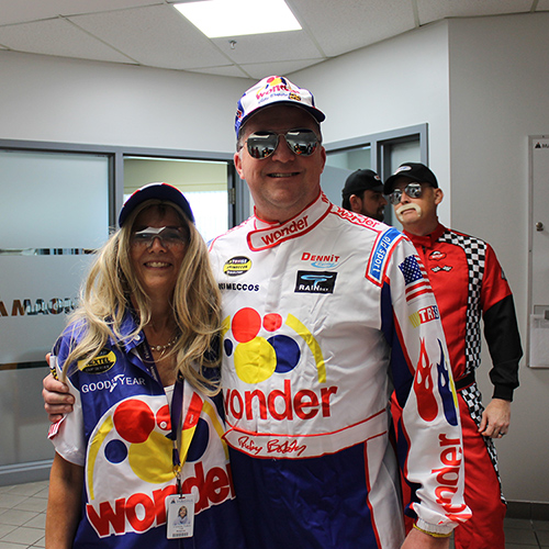 Paul Blackburn and an employee dressed in Nascar outfits