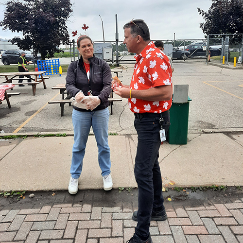 Paul Blackburn talking with an employee at a company event